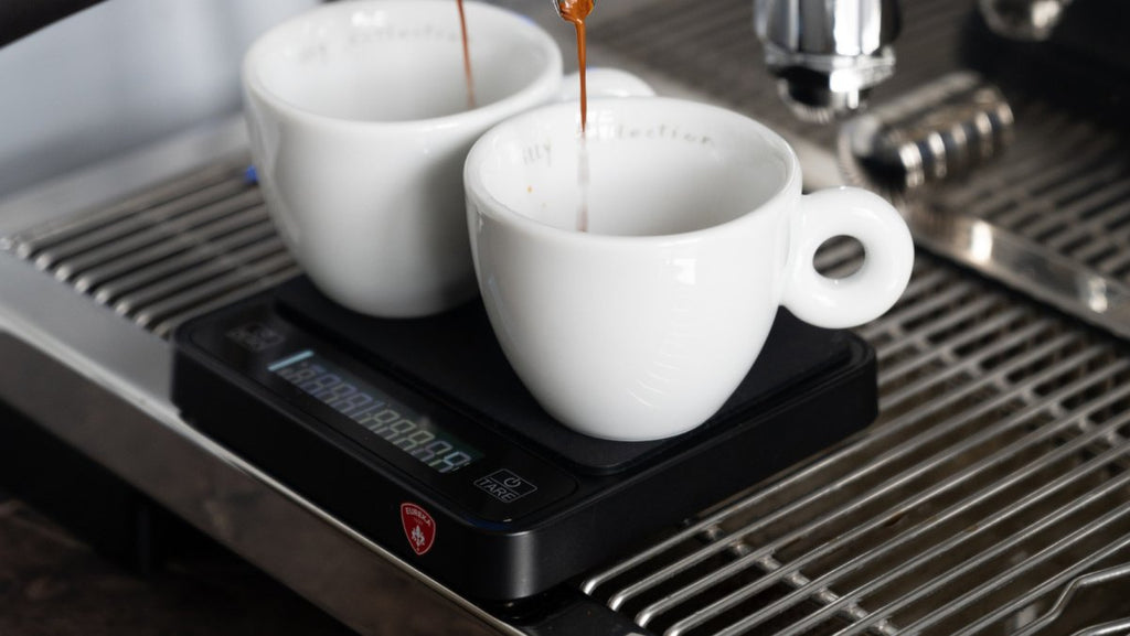 Two espresso cups on the Eureka Precisa scale under the espresso machine